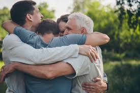 4 people hugging each other in a circle